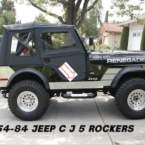 May include: A black Jeep CJ5 Renegade with a black soft top and silver accents. The Jeep has a silver diamond plate on the sides and a silver Renegade decal on the hood.