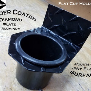 May include: Black powder coated cup holder with a diamond plate finish. The cup holder has a rubber insert and mounts on any flat surface. "POWDER COATED DIAMOND PLATE ALUMINUM" and "MOUNTS ON ANY FLAT SURFACE" are printed on the cup holder.