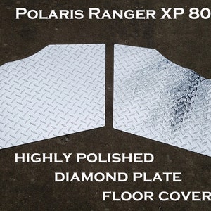 May include: Two silver diamond plate floor covers for a Polaris Ranger XP 800. The floor covers are highly polished and have a diamond pattern.