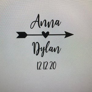 Può includere: Grafica in bianco e nero con una freccia che punta a destra, un cuore al centro e i nomi Anna e Dylan con la data 12.12.20 sotto.