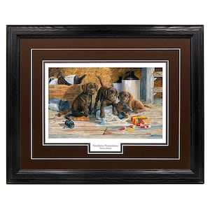 May include: A framed print of a painting depicting four chocolate brown Labrador Retriever puppies playing with hunting supplies in a barn. The print is titled "Northern Promotions" with the artist's name below.