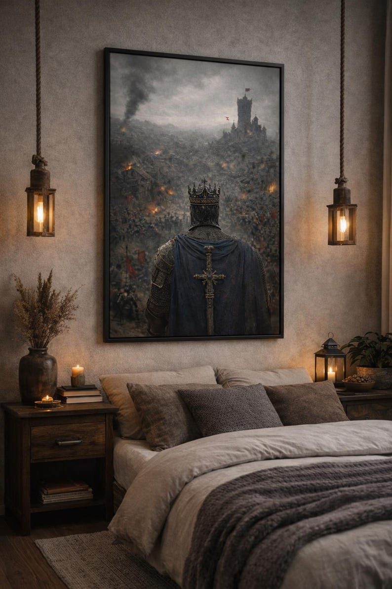 May include: A framed artwork depicts a medieval king in armor, facing a battlefield with a castle in the distance. The king wears a crown and a blue cape with a cross. The scene is set in a bedroom with warm lighting and a bed.