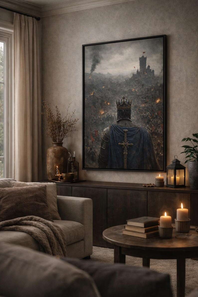 May include: A framed artwork depicting a medieval knight with a crown and blue cape, facing a battlefield with a castle in the background. The artwork is displayed in a living room setting with a sofa, candles, and a dark wood cabinet.