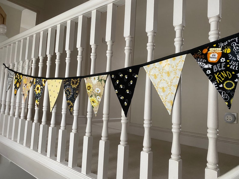 Bee Lovers Honey Hive Inspirational Quote Bee Kind Sunflower Black and Yellow Cotton Fabric Bunting by Bluebell Bunting. Medium bunting tied to the spindles of the stairs landing.