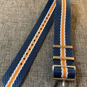 May include: A blue watch strap with white and orange stripes. The strap has a silver buckle.