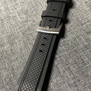 May include: Black rubber watch strap with a textured pattern and a silver buckle.