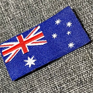 May include: An embroidered patch featuring the Australian flag. The flag is blue with a white Southern Cross constellation and the Union Jack in the top left corner.