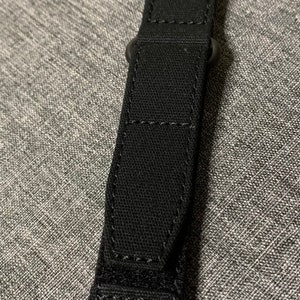May include: Black watch strap with a stitched design and a buckle.