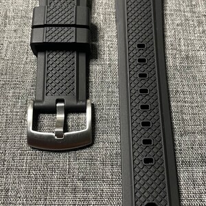 May include: Two black watch straps with a textured pattern. One strap has a silver buckle.