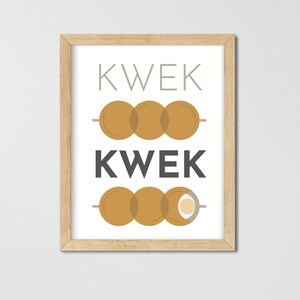 May include: A framed print with the word "KWEK" written in black text on a white background. The word is repeated twice, with a graphic of three brown, round objects on a stick between each word.