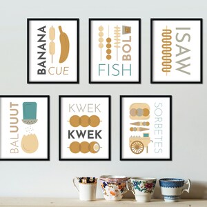 May include: Set of 8 black framed prints with illustrations of Filipino street food. The prints feature the text "Banana Cue", "Fish Ball", "Isaw", "Balut", "Kwek Kwek", and "Sorbetes".