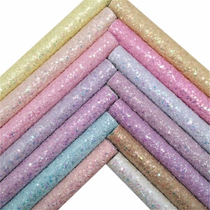 May include: A set of 12 rolls of iridescent glitter fabric in various pastel colors, including pink, purple, blue, and yellow. The fabric is textured and has a sparkly finish.