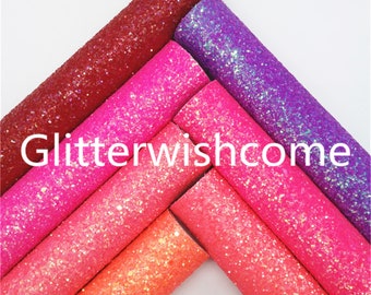 May include: A collection of colorful glitter sheets in shades of red, pink, and purple. The sheets are rolled up and arranged diagonally, with the text "Glitterwishcome" in white across the bottom.
