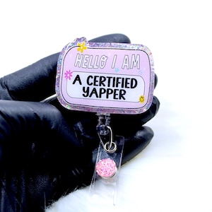 May include: Pink glitter badge holder with a pink and white rectangle that says "Hello I am a certified yapper".