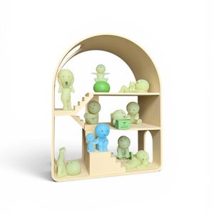 May include: A wooden dollhouse-style shelf filled with various small, stylized figurines in shades of green and blue. The shelf has an arched top and multiple levels, with the figurines arranged on the steps and shelves. Some figurines are in the shape of people.