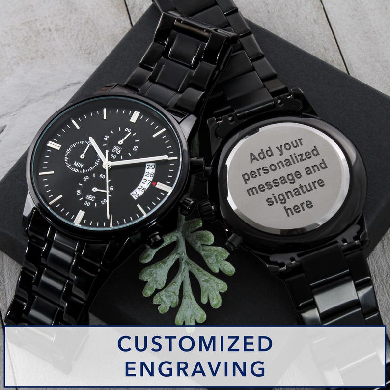 May include: Two black chronograph watches with matching black metal bands. One watch face displays the time, date, and sub-dials. The other watch has a silver back with the text "Add your personalized message and signature here". The image also includes the text "CUSTOMIZED ENGRAVING".