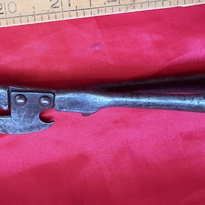 Antique/vintage metal can opener as a registration number on the underside and marking on the blade.