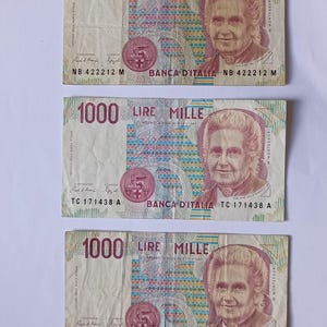 May include: Three Italian 1000 Lire banknotes featuring a portrait of Maria Montessori, the text "LIRE MILLE", and the words "BANCA D'ITALIA".
