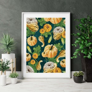 May include: A white framed print with a teal background featuring a pattern of gourds and pumpkins in shades of yellow, orange, and white.