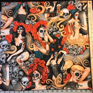 May include: A colorful fabric with a repeating pattern of women with sugar skulls and floral accents. The background is gray with swirls and skulls.