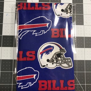May include: Blue fabric with a white buffalo and red "BILLS" text repeated. The fabric also features a white football helmet with a black facemask.