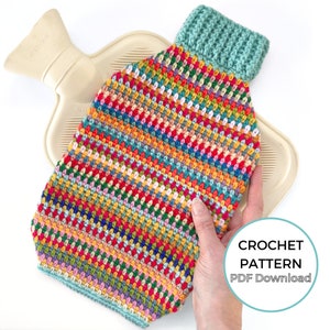 May include: A colorful crochet hot water bottle cover with a teal crocheted top. The cover is made with a variety of colors, including red, orange, yellow, green, blue, and purple. The cover is being held by a hand, and a hot water bottle is visible inside the cover. The text "CROCHET PATTERN PDF Download" is visible in the lower right corner of the image.
