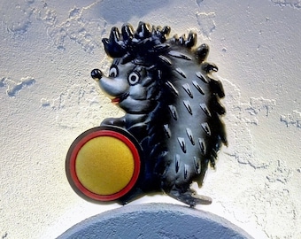 Vintage wall-mounted pincushion in the shape of a hedgehog. Used for needles
