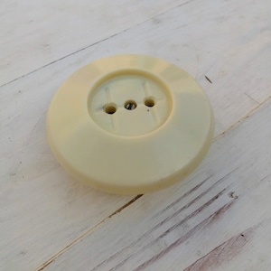 May include: A white plastic electrical outlet cover with three round holes.