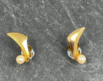 A dainty pair of gold tone vintage earrings set with small faux pearl, these are clip on earrings