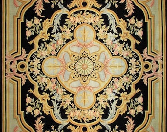 May include: A black rug with a floral pattern in shades of pink, yellow, and blue. The rug has a central medallion with a geometric design.