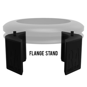 May include: Black plastic flange stand with the text "RA BROOKLYN NY" on each side. The stand is designed to hold a round object, such as a record player turntable.