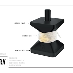 May include: A black 3D printed cord blocking stand with a white cord wrapped around it. The stand has a non-slip base and a blocking cord. The stand is labeled "RA" and is made from 100% biodegradable sustainable material. Made in the USA.