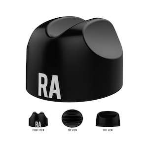 May include: A black, curved object with the letters "RA" in white. The image includes front, top, and side views of the object. The top has a grooved design. The object appears to be a stand or holder.