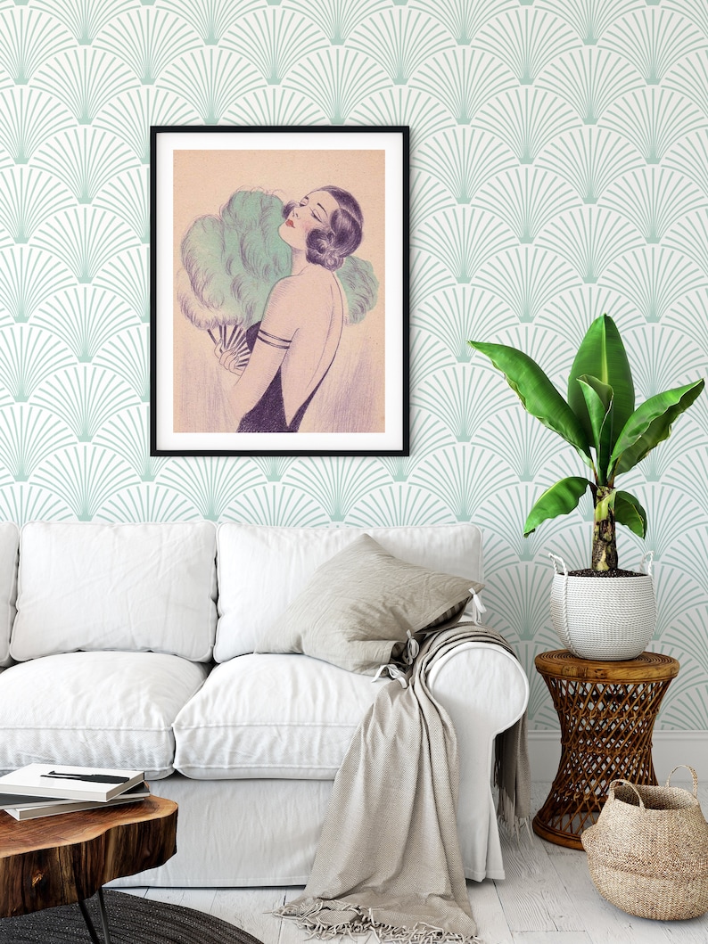living room with a couch, a side table with a plant, and a wall with art deco wallpaper and a 1920's framed portrait