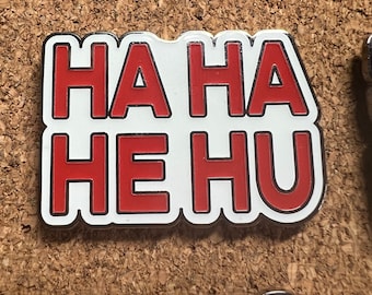 Hahahehu Glow in the Dark Hard Enamel pin by @musicfestivalstickers. 1.5 inches LE 111