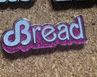 Daily Bread pink glitter Hard Enamel pin by @musicfestivalstickers + @PatchAndStash. 1.5 inches LE 111