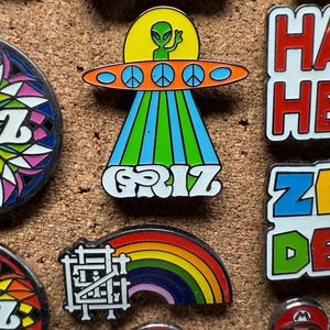 Griz UFO and Griz Rainbow glow in the dark Hard Enamel pins by @musicfestivalstickers