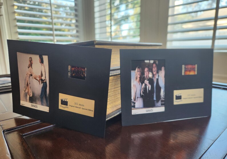May include: Two black framed film memorabilia, each with film stills and a 35mm film strip. The frames display images from the movie, with a gold plaque that reads "Original Lithograph Special Edition".