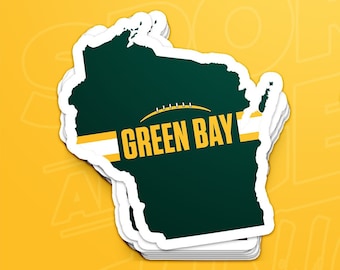May include: Two Green Bay Packers stickers featuring the state of Wisconsin with the team's logo and the words "Green Bay" in gold lettering.