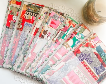 May include: A collection of rectangular paper envelopes featuring various holiday-themed patterns, including snowflakes, candy canes, and festive colors. The envelopes are arranged in a fan shape, each containing assorted decorative paper scraps.