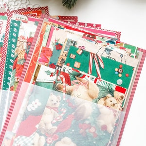 May include: A stack of vintage Christmas wrapping paper featuring a variety of holiday designs, including candy canes, ornaments, and bears. The paper is in a clear plastic sleeve.