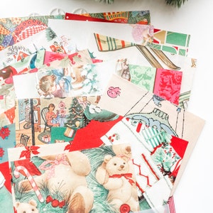 May include: A collection of vintage Christmas paper scraps with various holiday themes, including a teddy bear, a Christmas tree, and a snowman. The papers are in shades of red, green, white, and blue.