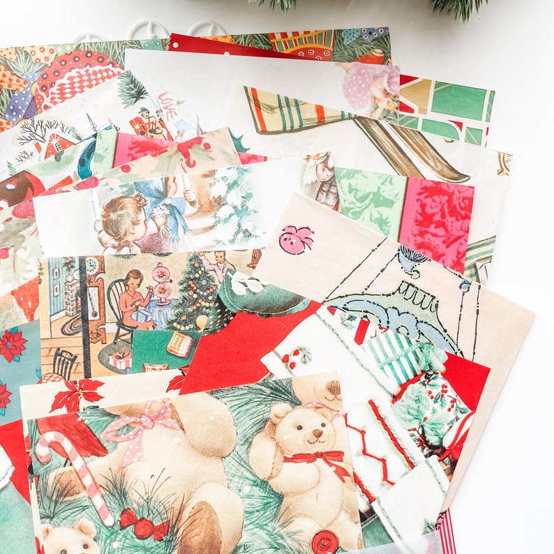 May include: A collection of vintage Christmas paper scraps with various holiday themes, including a teddy bear, a Christmas tree, and a snowman. The papers are in shades of red, green, white, and blue.