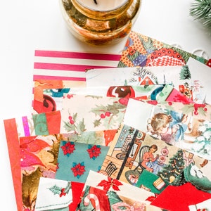May include: A collection of vintage Christmas paper scraps in various colors and patterns, including red, green, white, and gold. The scraps feature images of Christmas trees, houses, and other holiday motifs.
