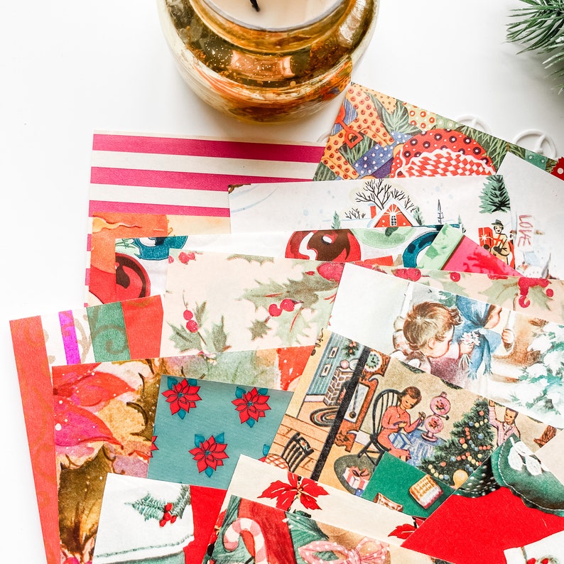 May include: A collection of vintage Christmas paper scraps in various colors and patterns, including red, green, white, and gold. The scraps feature images of Christmas trees, houses, and other holiday motifs.