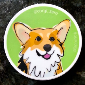 May include: A sticker featuring a cartoon illustration of a corgi with a green background. The corgi is smiling and has a pink tongue. The text "@corgi_zero" and "#corgis" are on the sticker.