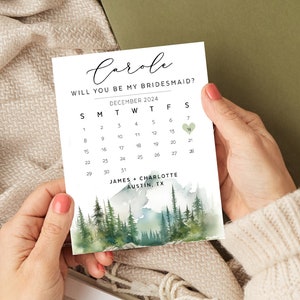 May include: A white card with green watercolor forest scene and a calendar with a heart marking December 7th. The text reads "Carole, Will you be my bridesmaid? December 2024, James + Charlotte, Austin, TX"