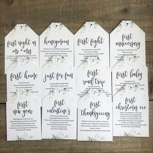 May include: Set of ten white tags with green foliage and black text. Each tag features a different milestone in a relationship, such as "first night as Mr. & Mrs." and "first Christmas Eve".