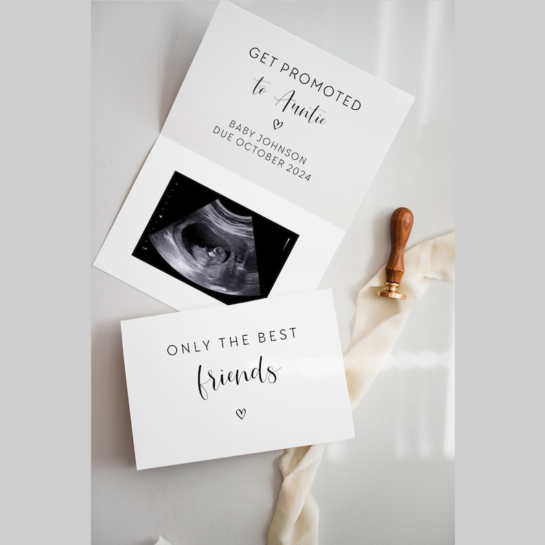 May include: A white card with black text announcing a promotion to "Auntie" with a heart symbol. The card includes a black and white ultrasound image and the text "Baby Johnson Due October 2024". A second white card with black text reads "Only the best friends" with a heart symbol.