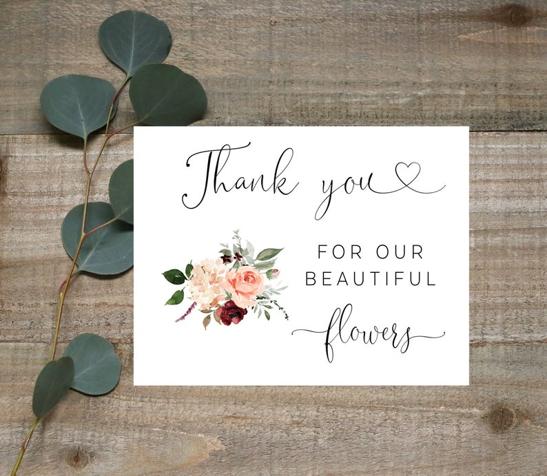 May include: Thank you for our beautiful flowers. A white card with black calligraphy and a watercolor floral illustration.